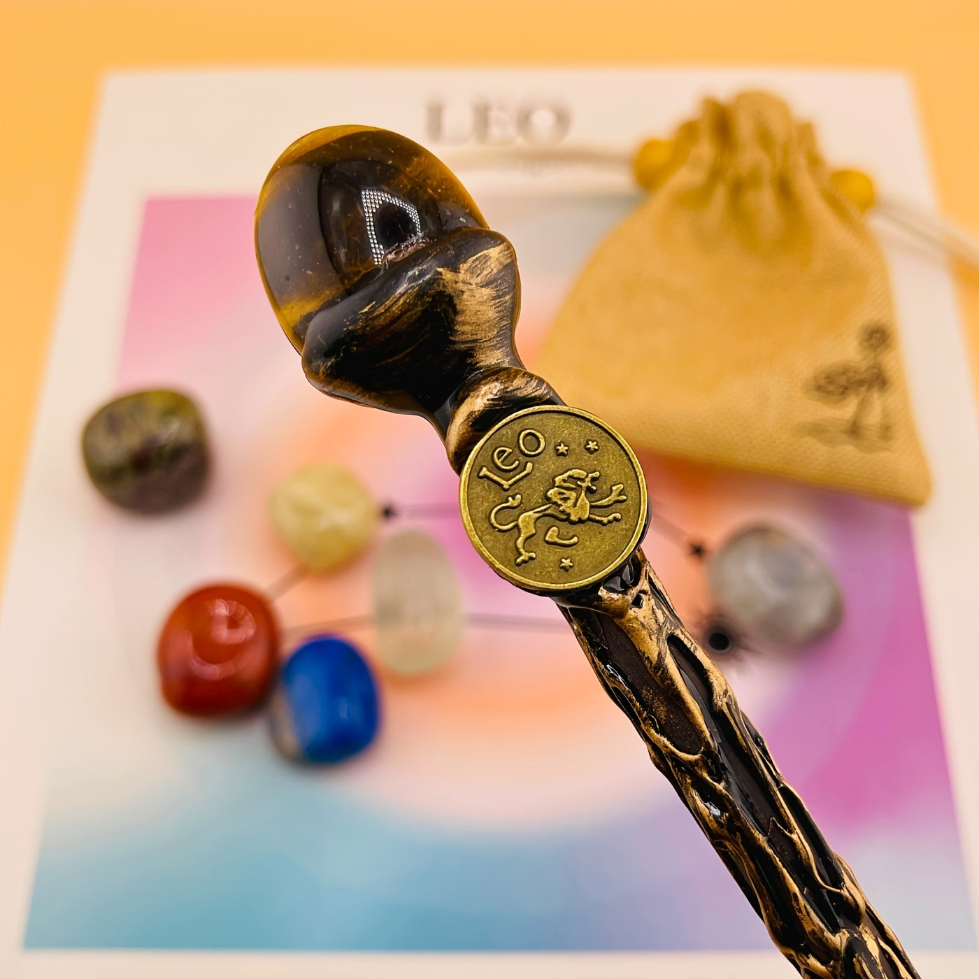 Decorative wand with 'Leo' emblem on a colorful background