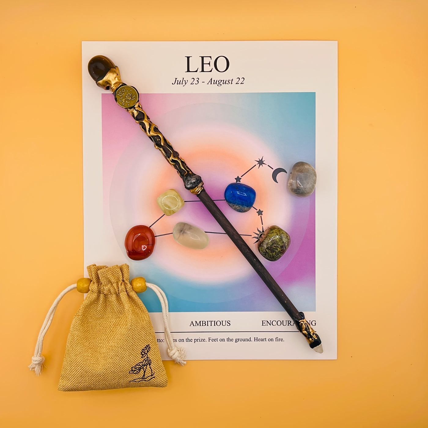 Decorative wand with gemstones on a Leo zodiac poster with a yellow background