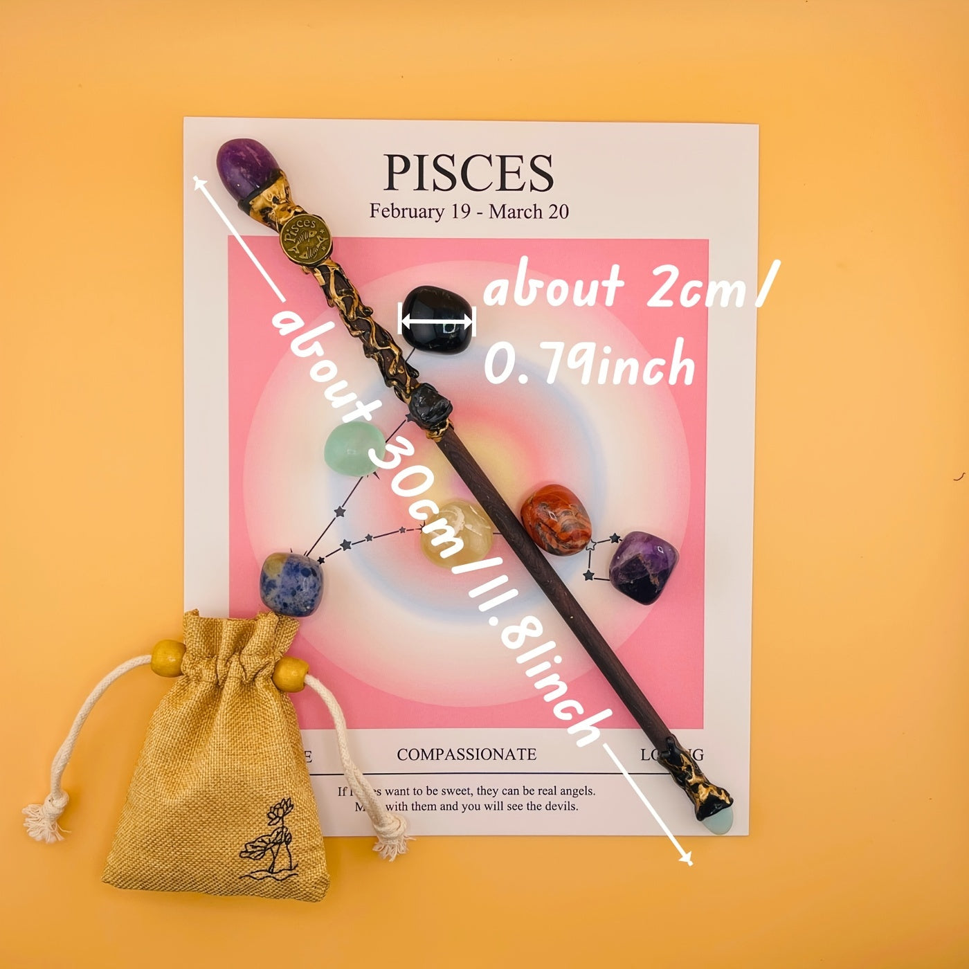Decorative hair stick with beads on a Pisces zodiac card against an orange background